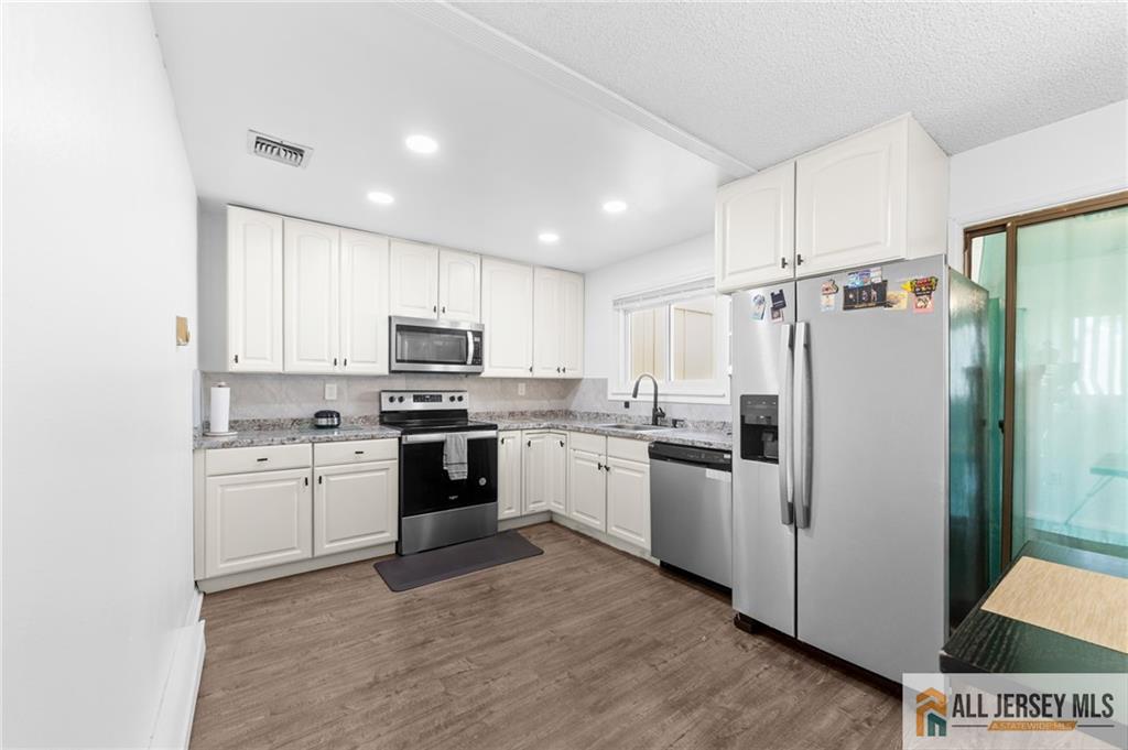 25C Pitman Road, Unit B Monroe Township, NJ 08831 - Photo 11 of 29 a kitchen with cabinets stainless steel appliances and sink