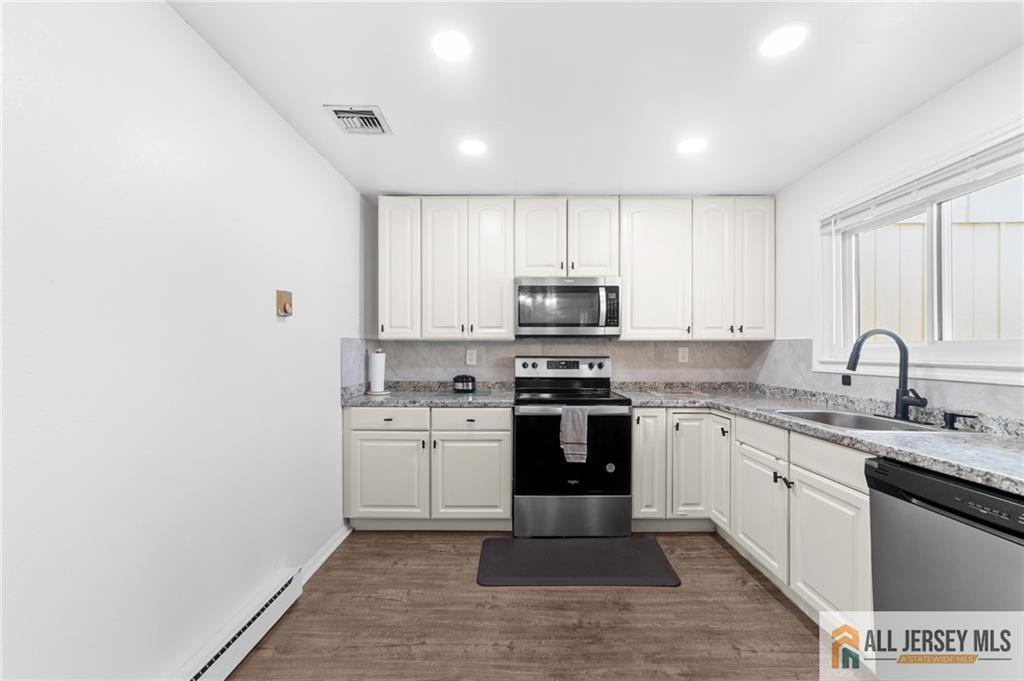 25C Pitman Road, Unit B Monroe Township, NJ 08831 - Photo 12 of 29 a kitchen with stainless steel appliances granite countertop a stove top oven a sink and dishwasher