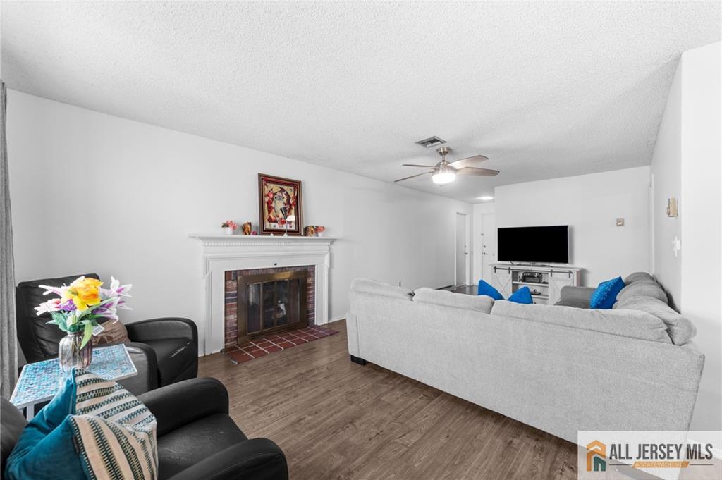 25C Pitman Road, Unit B Monroe Township, NJ 08831 - Photo 10 of 29 a living room with furniture and a fireplace