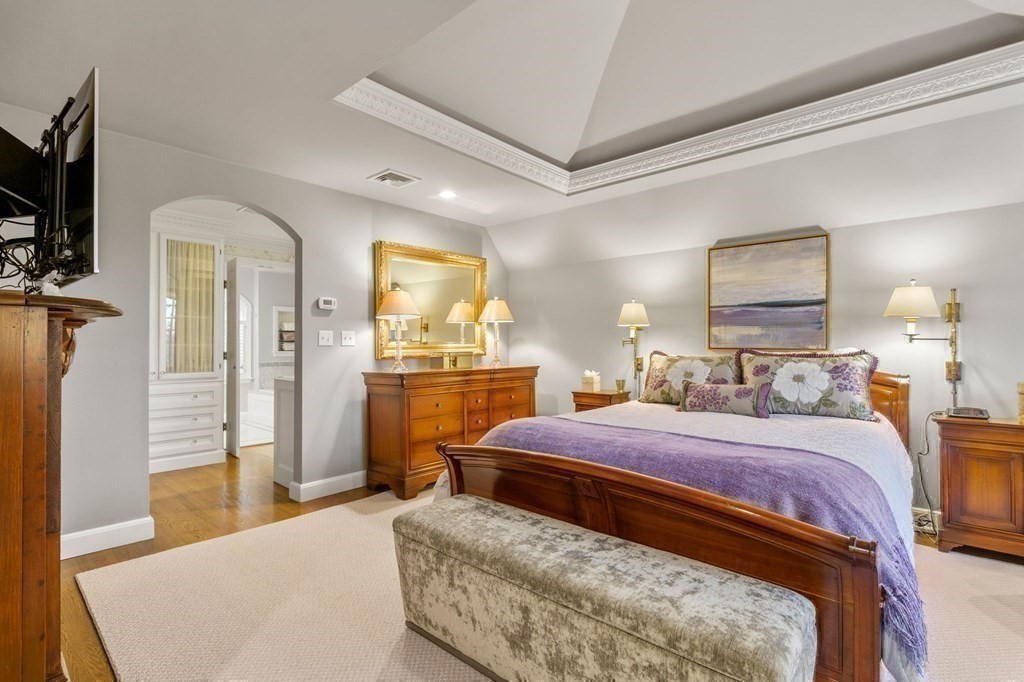 37 Boulder Road Wellesley, MA 02481 - Photo 26 of 42 a bedroom with a bed a mirror and a flat tv screen on dresser