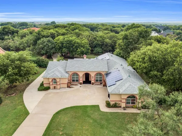 an aerial view of a house with garden space and street view
