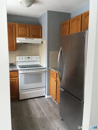 a stove top oven sitting inside of a kitchen