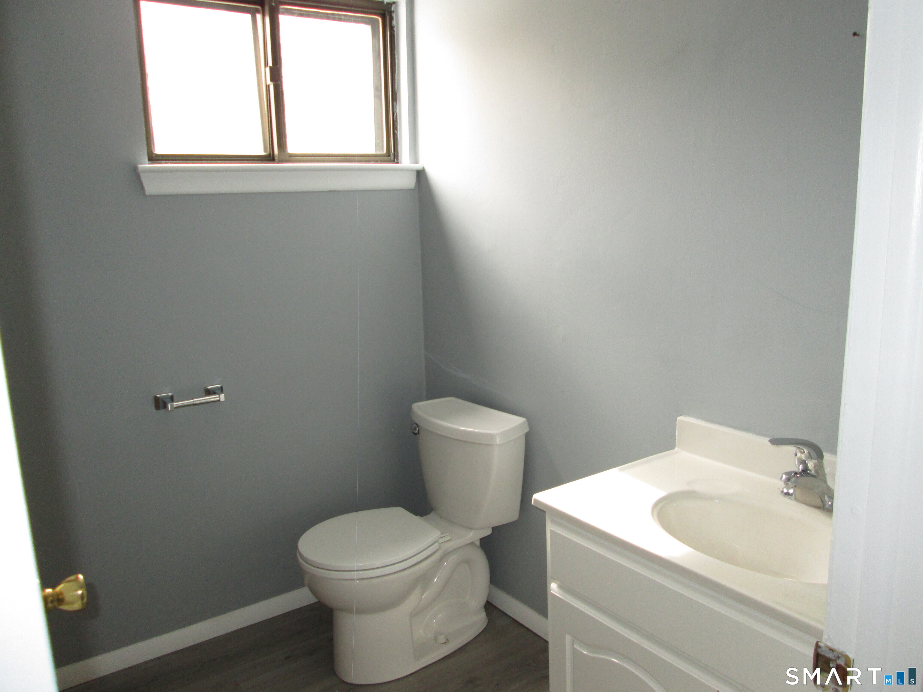 285 Queen Street, Unit 4F Southington, CT 06489 - Photo 18 of 22 a white toilet sitting next to a white sink and vanity