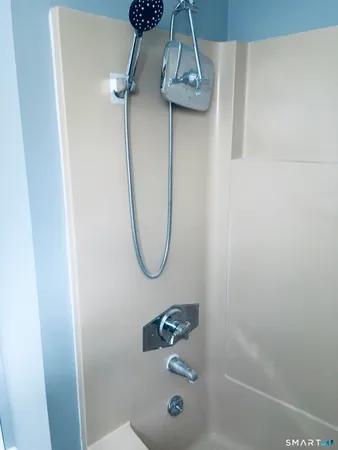 a bathroom with a shower and mirror