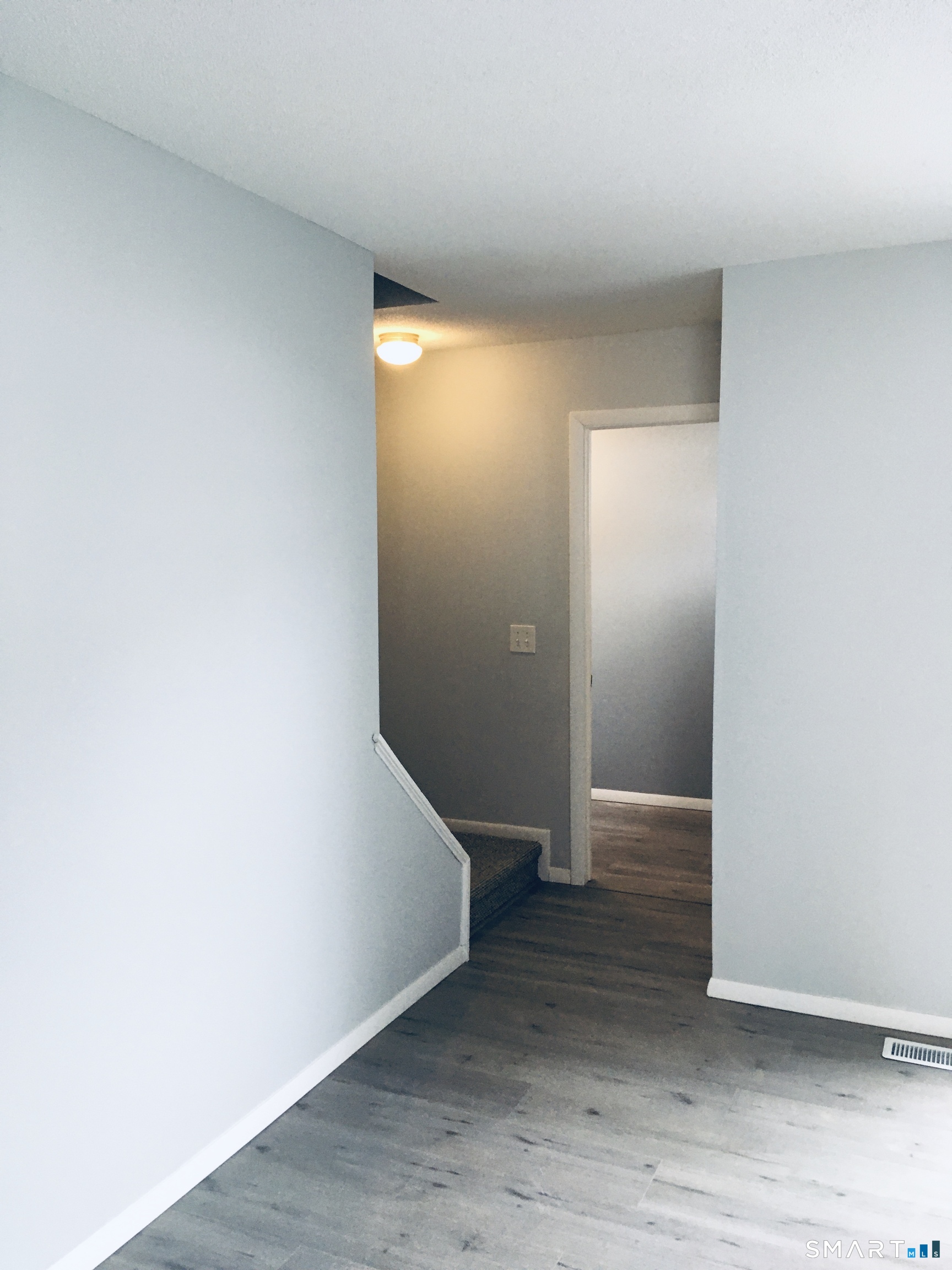 285 Queen Street, Unit 4F Southington, CT 06489 - Photo 7 of 22 an empty room with wooden floor and entrance