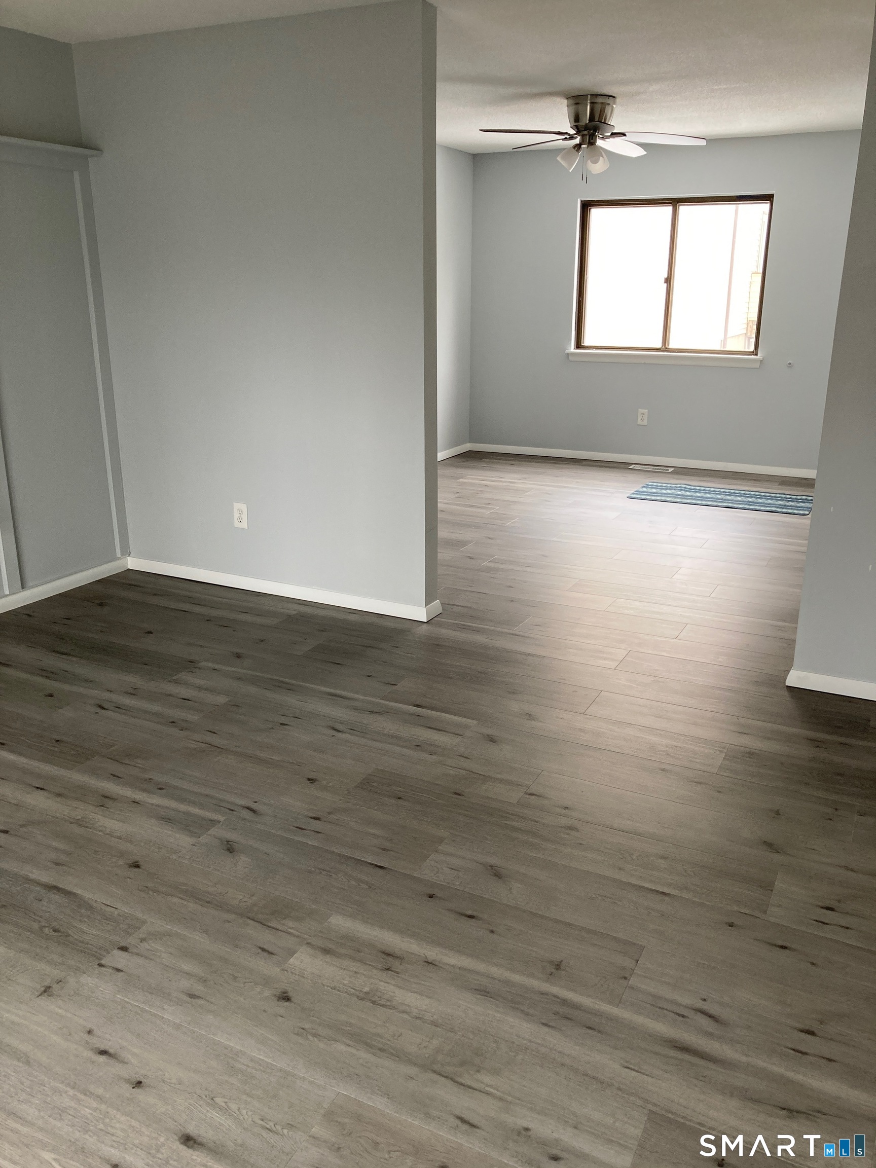 285 Queen Street, Unit 4F Southington, CT 06489 - Photo 8 of 22 a view of empty room with wooden floor and fan