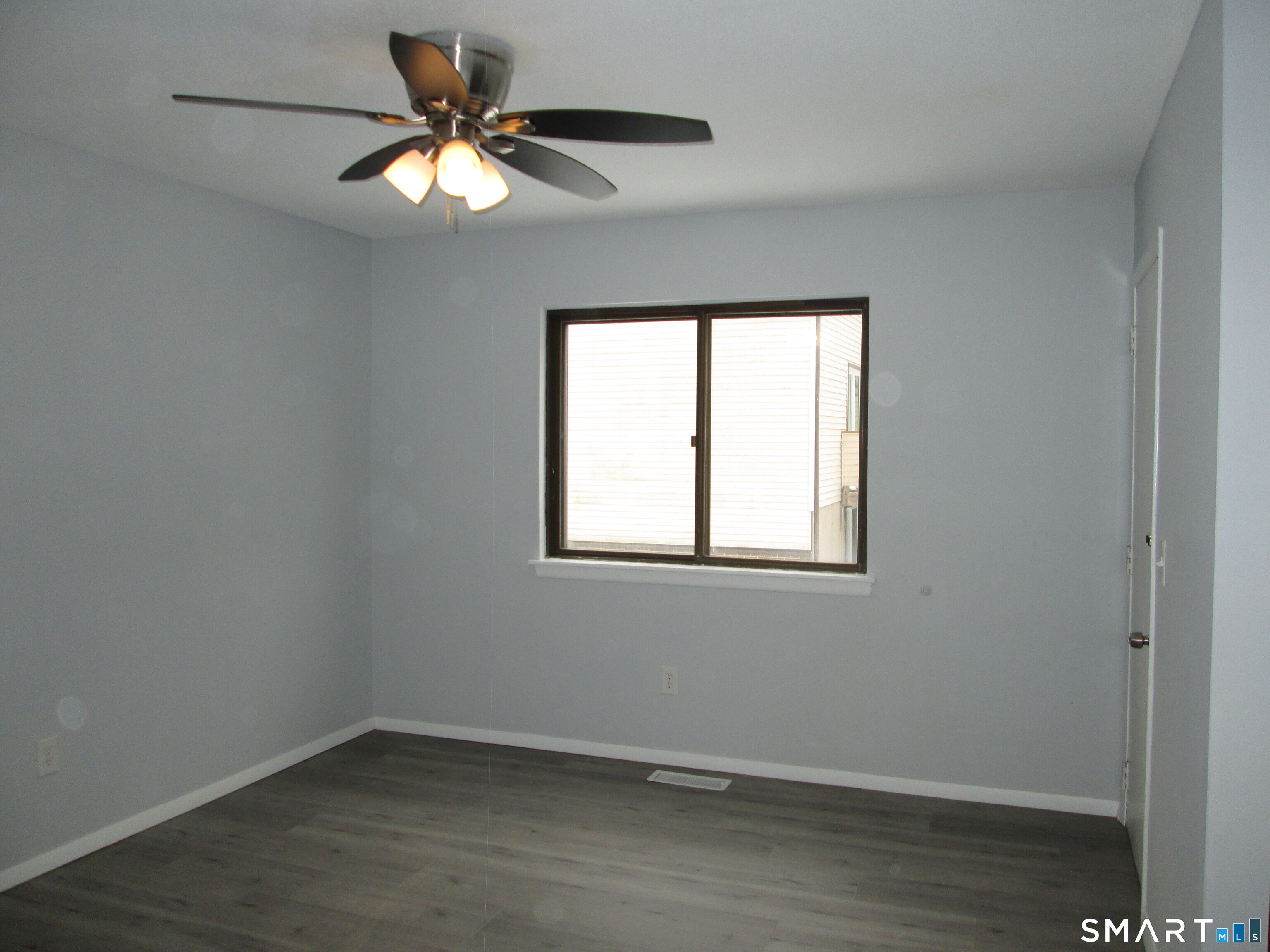 285 Queen Street, Unit 4F Southington, CT 06489 - Photo 9 of 22 an empty room with a window and a fan