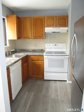 a kitchen with a stove sink and a refrigerator