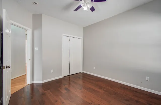 a view of an empty room with wooden floor