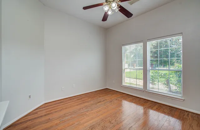 wooden floor in an empty room with a window