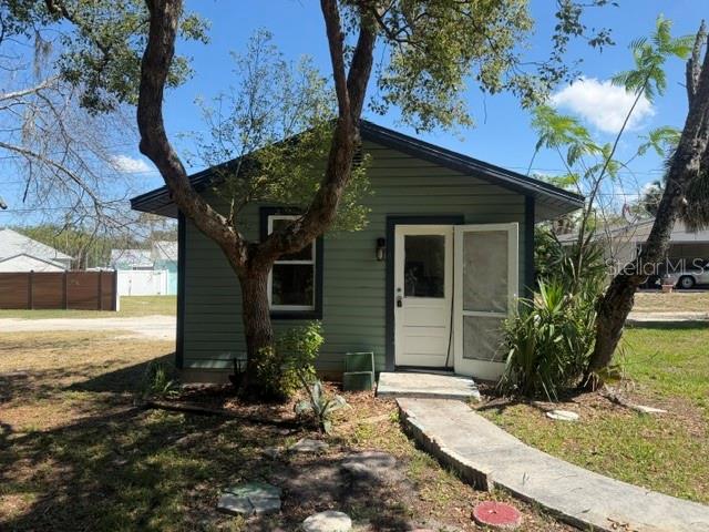 6921 Washington Street, Unit 4 New Port Richey, FL 34652 - Photo 1 of 5 a front view of house with yard