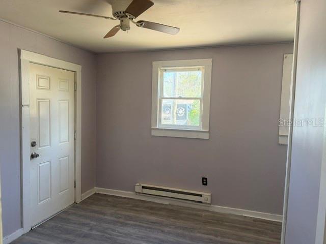 6921 Washington Street, Unit 4 New Port Richey, FL 34652 - Photo 4 of 5 an empty room with wooden floor and windows