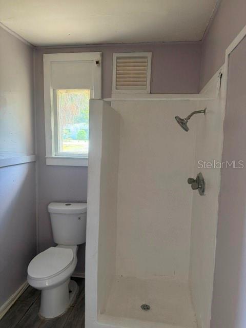 6921 Washington Street, Unit 4 New Port Richey, FL 34652 - Photo 5 of 5 a bathroom with a toilet sink and a shower
