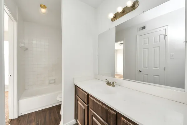 a bathroom with a tub and a sink