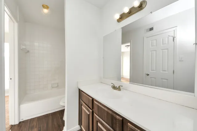 a bathroom with a tub and a sink