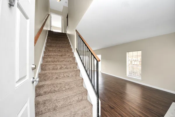 a view of an entryway with wooden floor