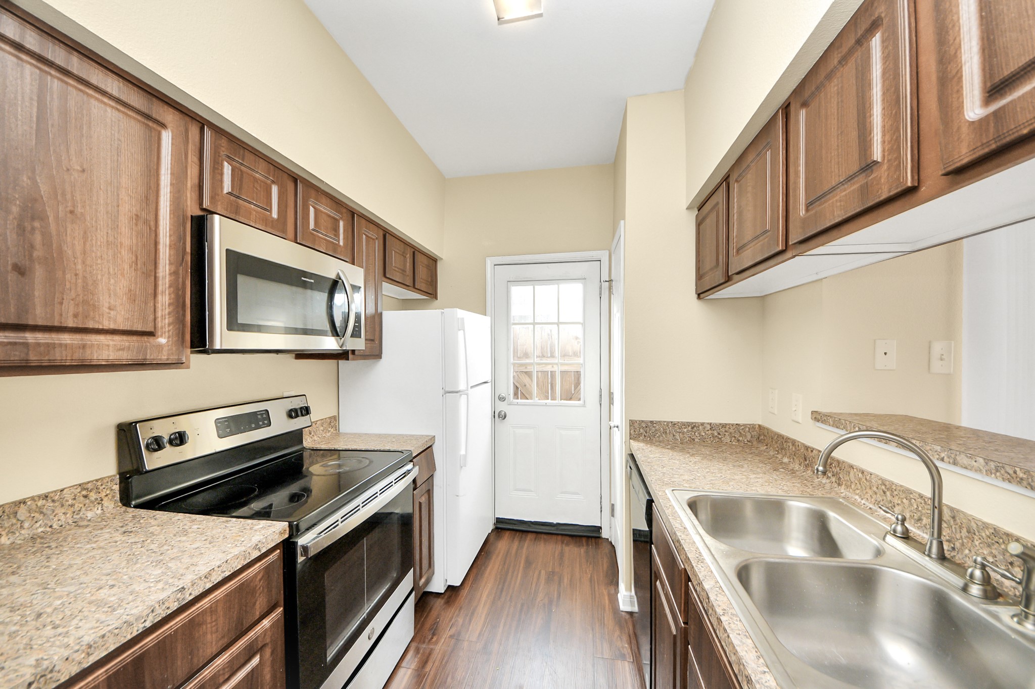 3600 Jeanetta Street, Unit 704 Houston, TX 77063 - Photo 10 of 21 a kitchen with granite countertop a stove and a sink
