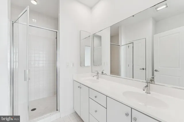 a bathroom with a shower sink and mirror