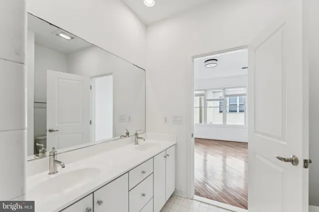 a bathroom with a sink double vanity and shower