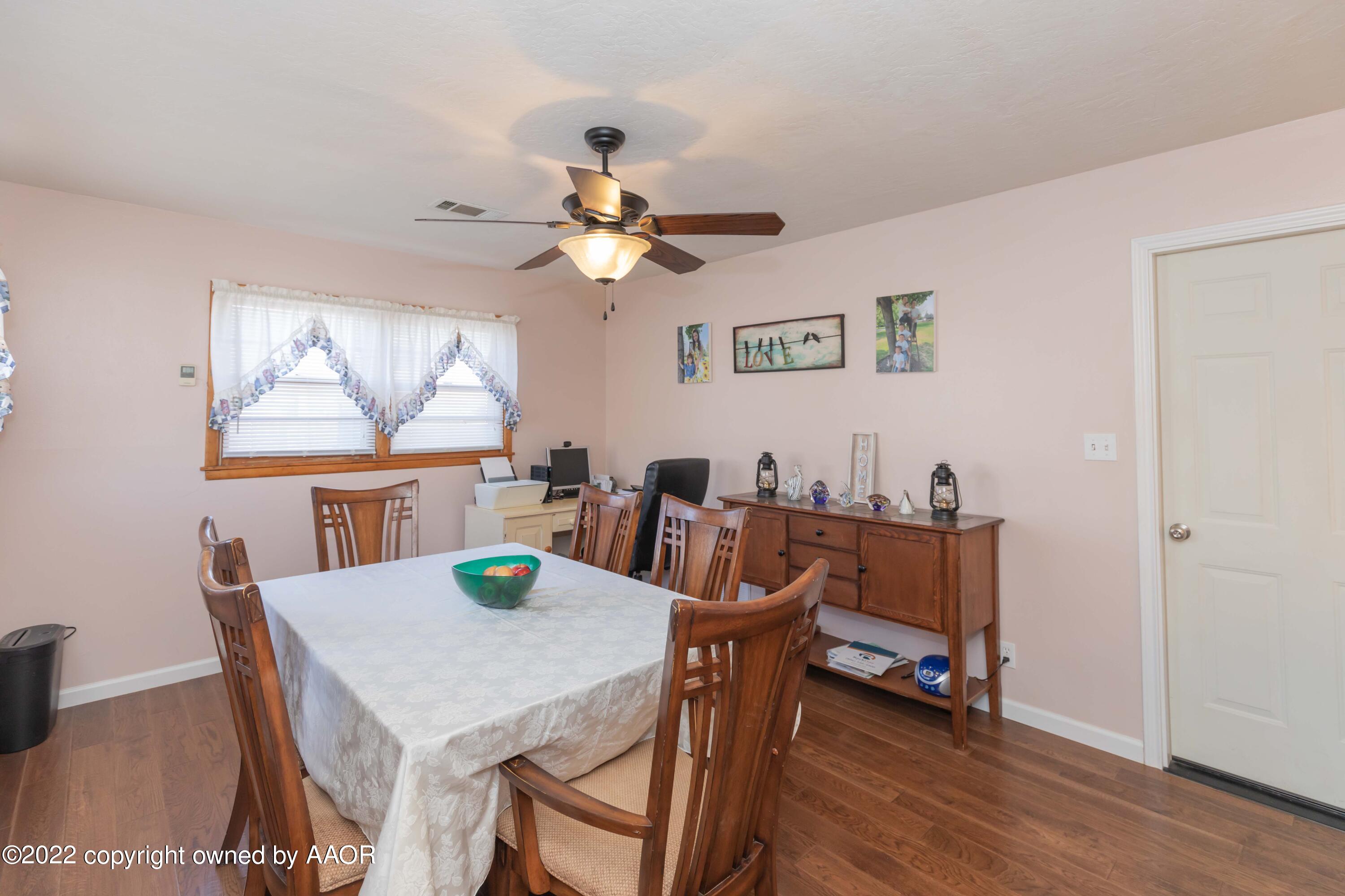 4706 South Bryan Street Amarillo, TX 79110 - Photo 15 of 40 a view of a dining room with furniture window and wooden floor