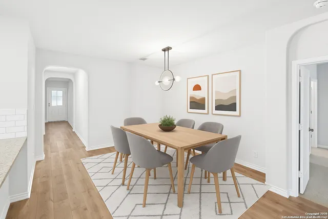 a view of a dining room with furniture and wooden floor