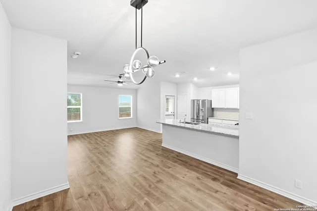 a view of kitchen with sink microwave and refrigerator