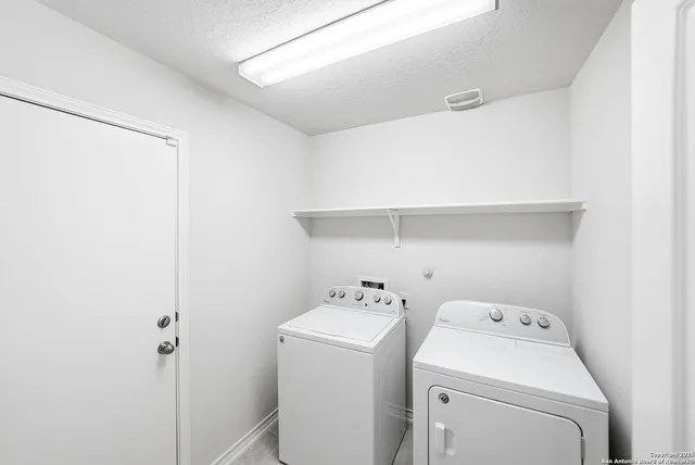 a view of storage and utility room with washer and dryer