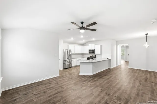 a view of kitchen with sink microwave and refrigerator
