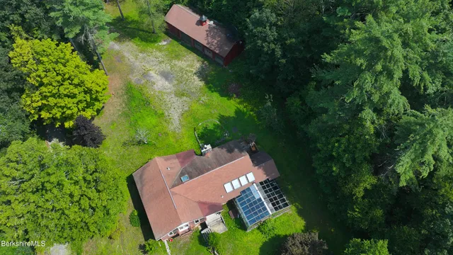 an aerial view of a house with garden space and street view