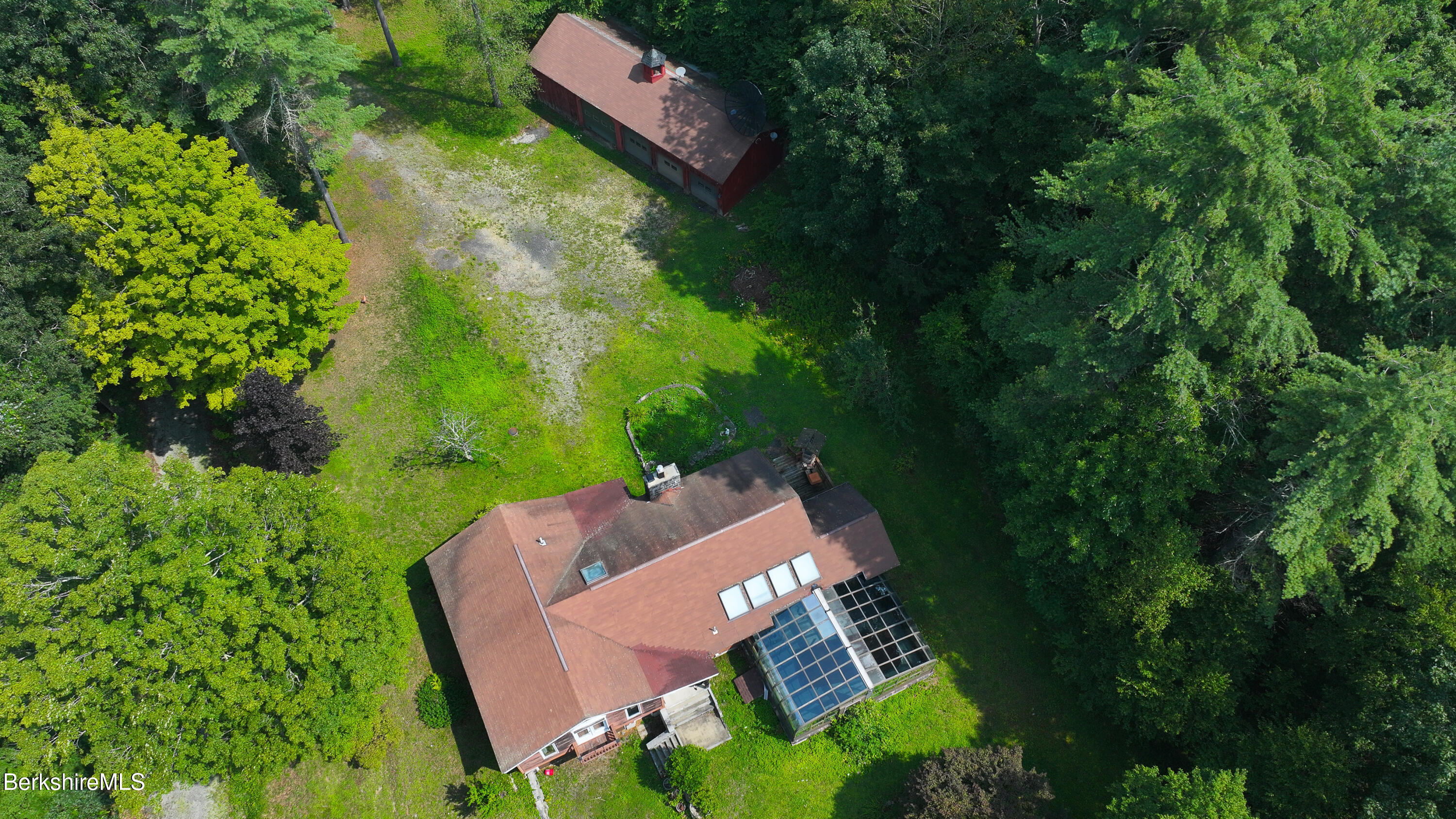 132 North Road Tolland, MA 01034 - Photo 2 of 8 an aerial view of a house with garden space and street view