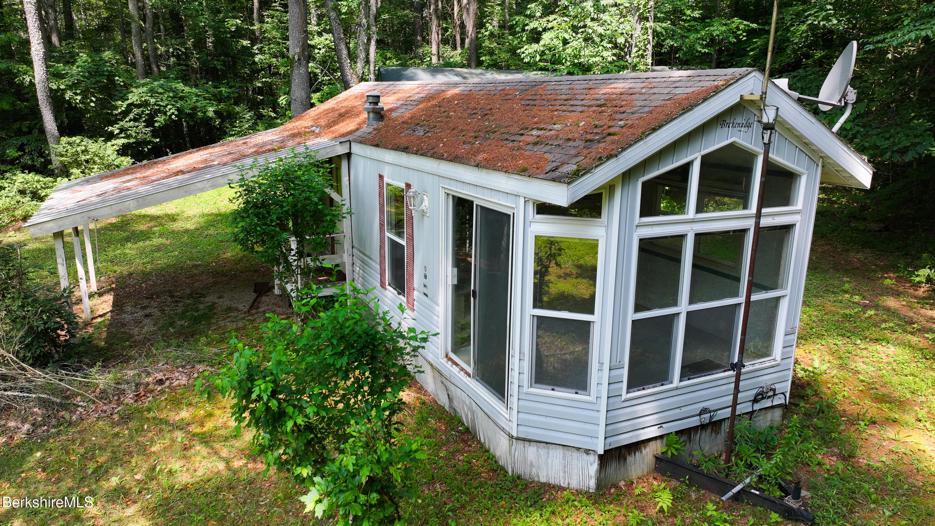 132 North Road Tolland, MA 01034 - Photo 4 of 8 a backyard of a house with large trees and plants