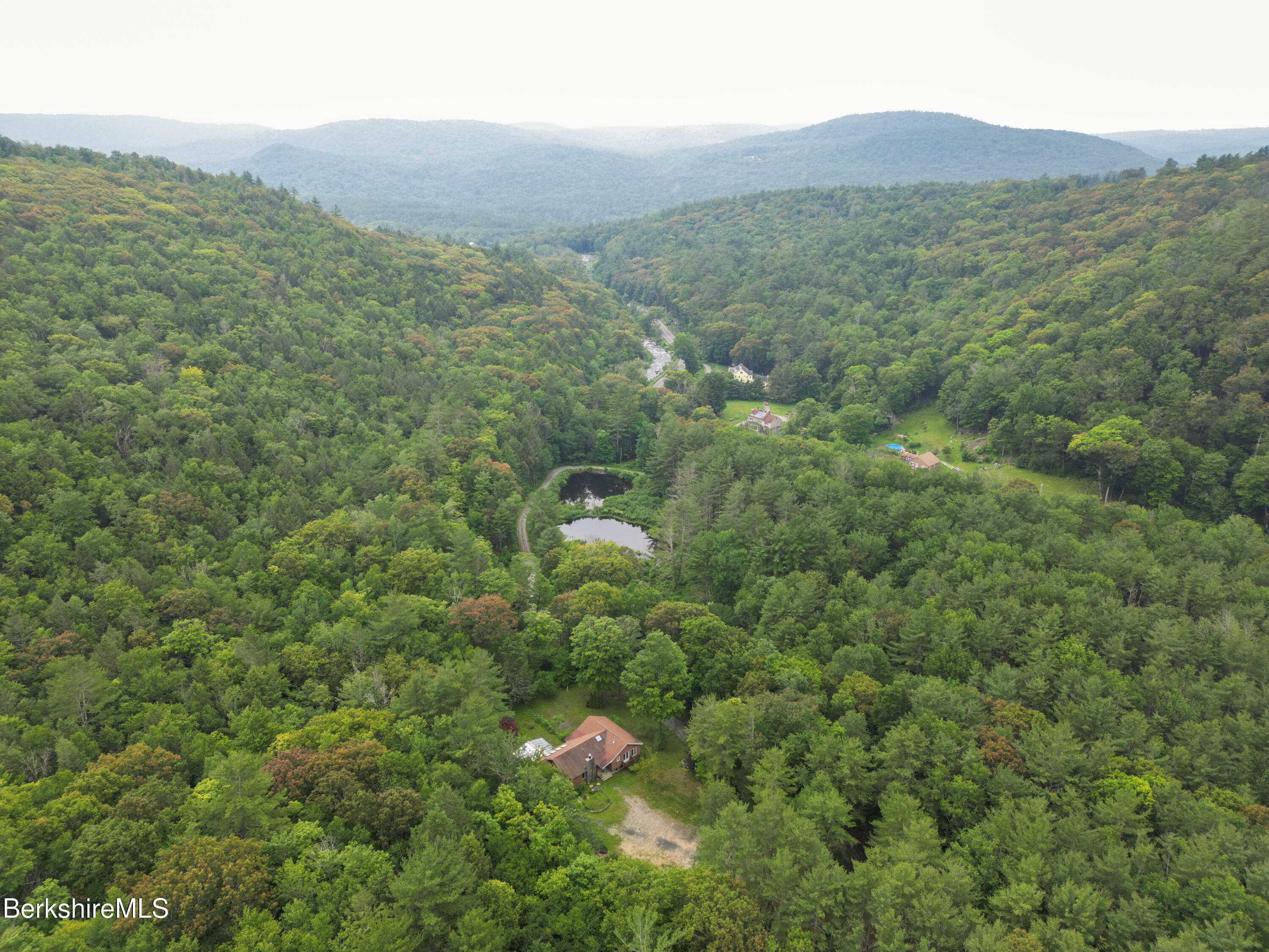 132 North Road Tolland, MA 01034 - Photo 8 of 8 a view of a lush green forest with a mountain