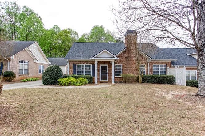 3402 Raes Creek Road, Unit 27 Marietta, GA 30008 - Photo 2 of 32 a front view of a house with a garden