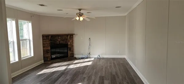 wooden floor in an empty room with a window