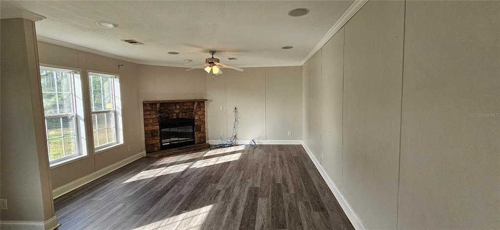 960 Still Road, Unit 1 Pierson, FL 32180 - Photo 19 of 67 a view of an empty room with wooden floor and a window