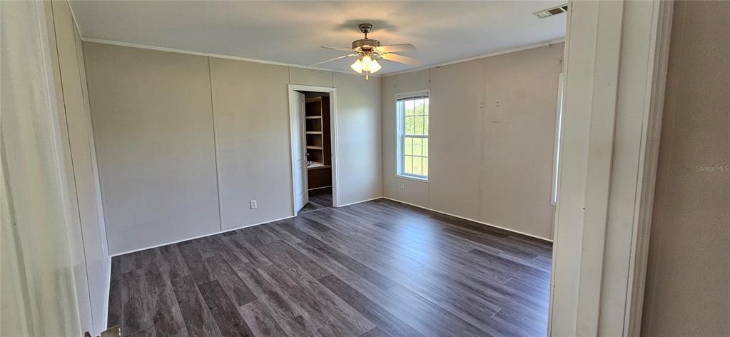 960 Still Road, Unit 1 Pierson, FL 32180 - Photo 20 of 67 a view of an empty room with window and wooden floor