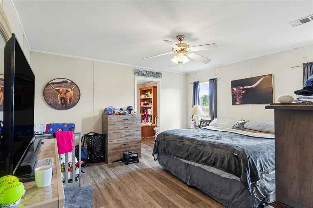 960 Still Road, Unit 1 Pierson, FL 32180 - Photo 22 of 67 a bedroom with a bed and a chandelier