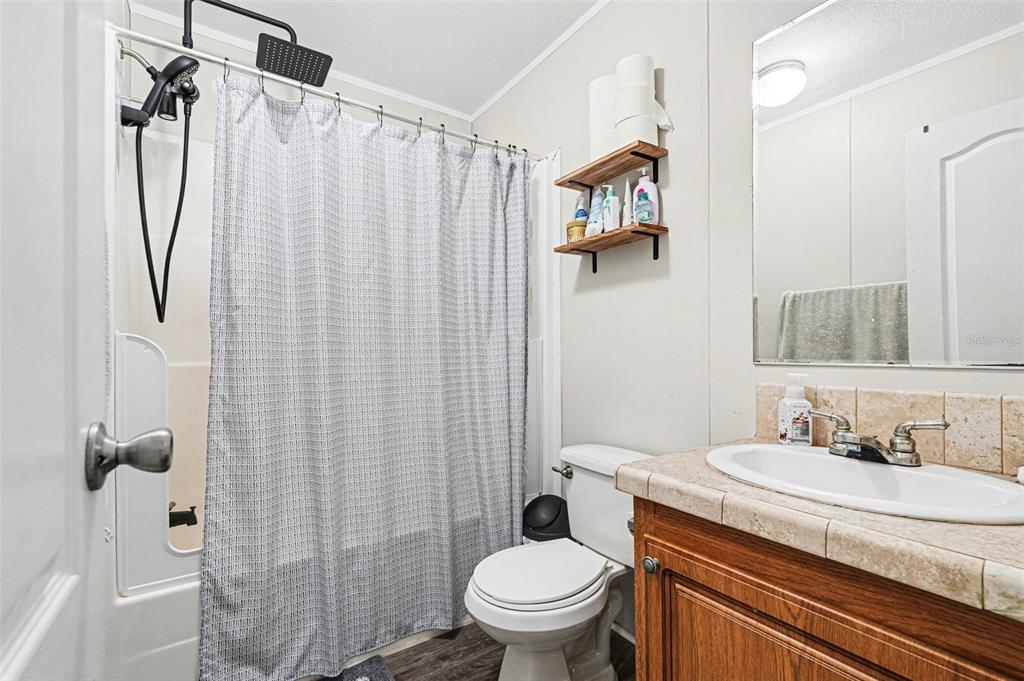 960 Still Road, Unit 1 Pierson, FL 32180 - Photo 32 of 67 a bathroom with a granite countertop sink toilet and shower
