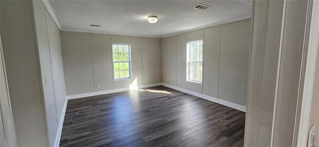 960 Still Road, Unit 1 Pierson, FL 32180 - Photo 33 of 67 a view of an empty room with wooden floor and a window