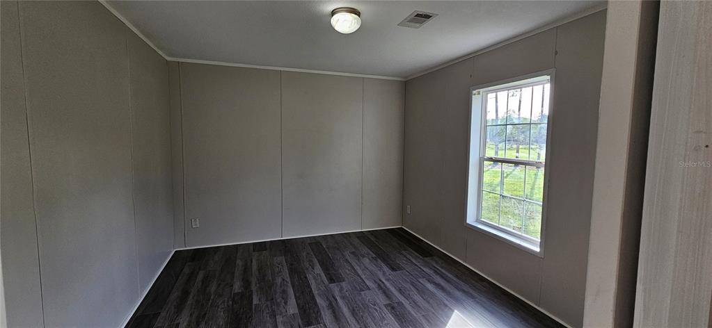 960 Still Road, Unit 1 Pierson, FL 32180 - Photo 39 of 67 a view of an empty room with wooden floor and a window