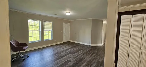 a view of a room with wooden floor