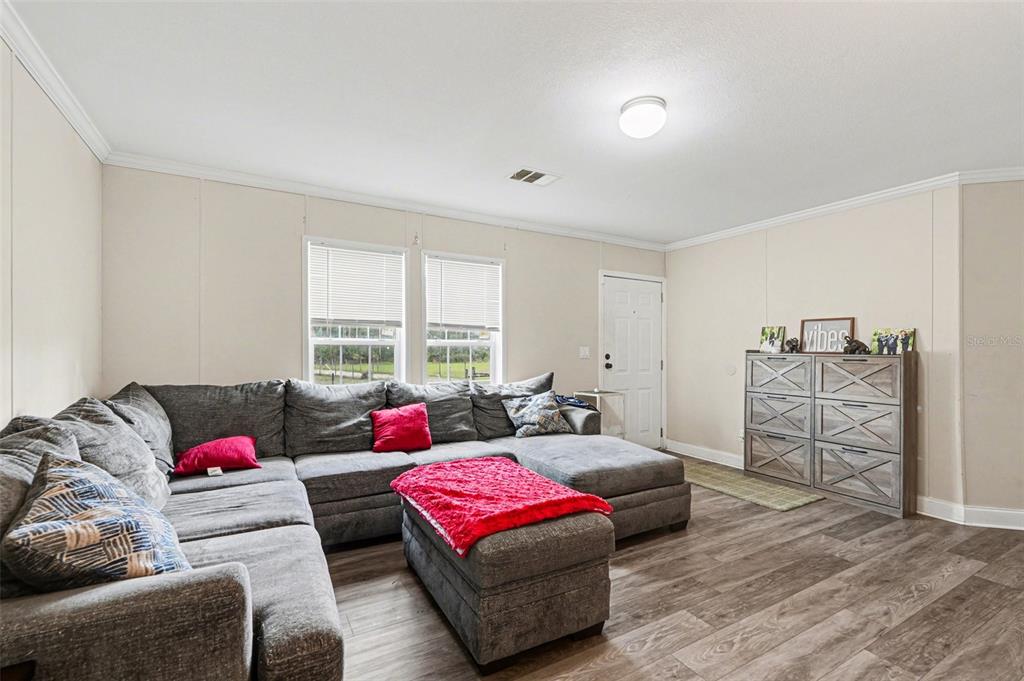 960 Still Road, Unit 1 Pierson, FL 32180 - Photo 6 of 67 a living room with furniture and a bed