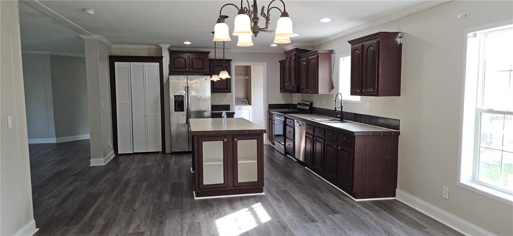 960 Still Road, Unit 1 Pierson, FL 32180 - Photo 7 of 67 a kitchen with stainless steel appliances granite countertop a stove a sink and a wooden floors