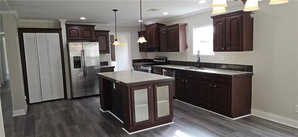 a kitchen with a sink appliances and cabinets
