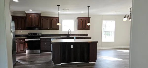 a kitchen with stainless steel appliances granite countertop a stove and a refrigerator