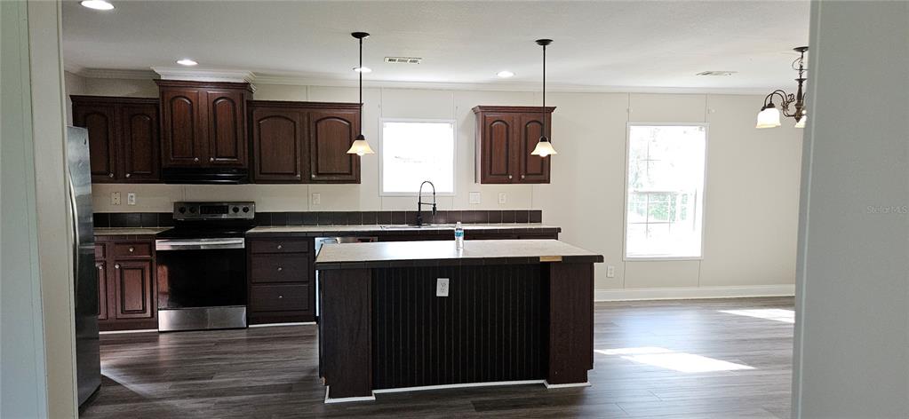 960 Still Road, Unit 1 Pierson, FL 32180 - Photo 9 of 67 a kitchen with a sink appliances and cabinets