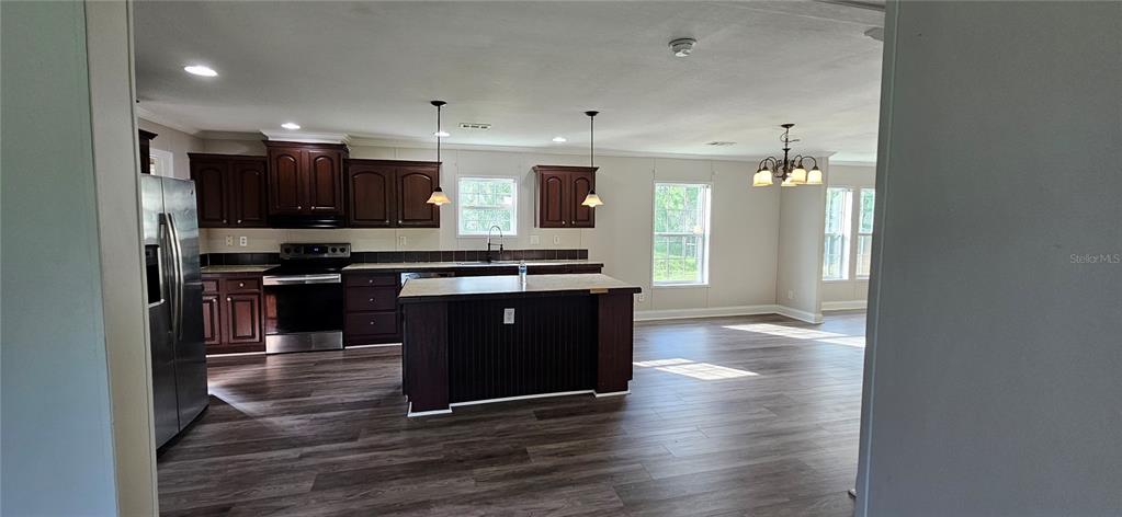 960 Still Road, Unit 1 Pierson, FL 32180 - Photo 10 of 67 a kitchen with stainless steel appliances granite countertop a stove and a refrigerator