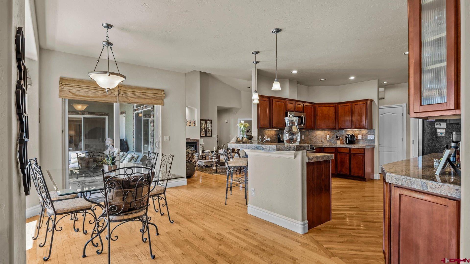 18222 6300th Road Montrose, CO 81403 - Photo 11 of 45 a living room with stainless steel appliances kitchen island granite countertop furniture a rug kitchen view and a chandelier
