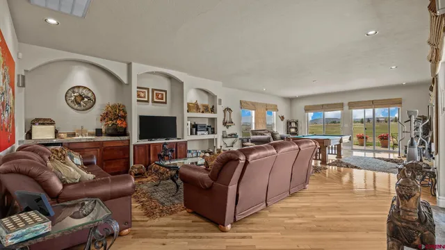 a living room with furniture and a wooden floor