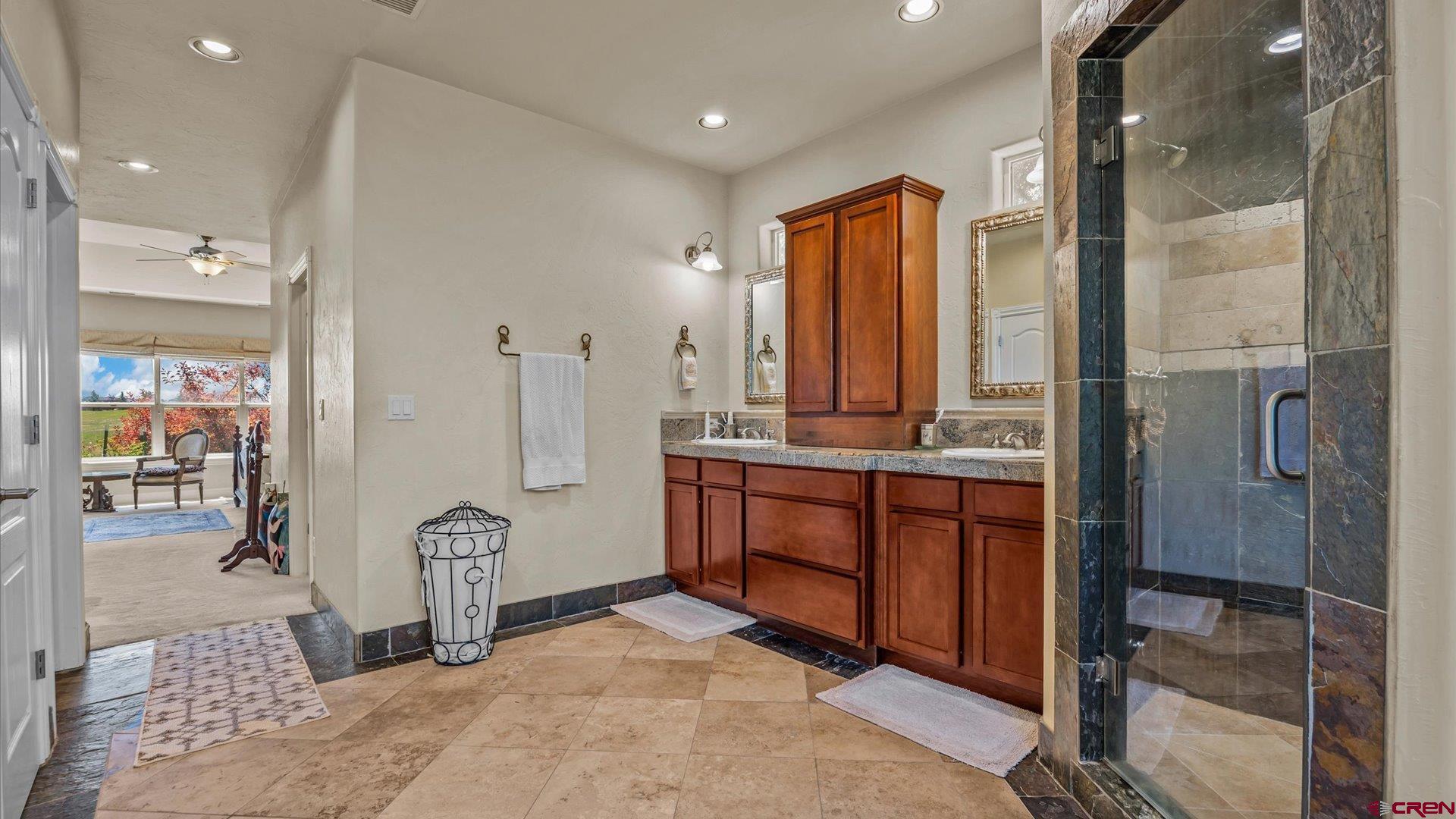 18222 6300th Road Montrose, CO 81403 - Photo 17 of 45 a bathroom with a sink a mirror and shower